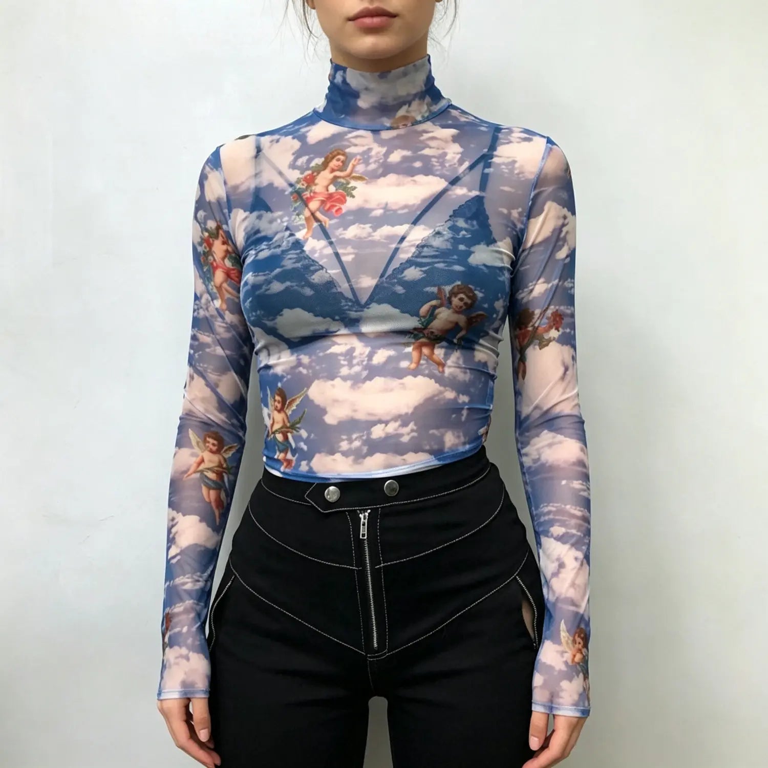 Studio model front view blue sheer mesh turtleneck long sleeve top with vintage cherub sky cloud print