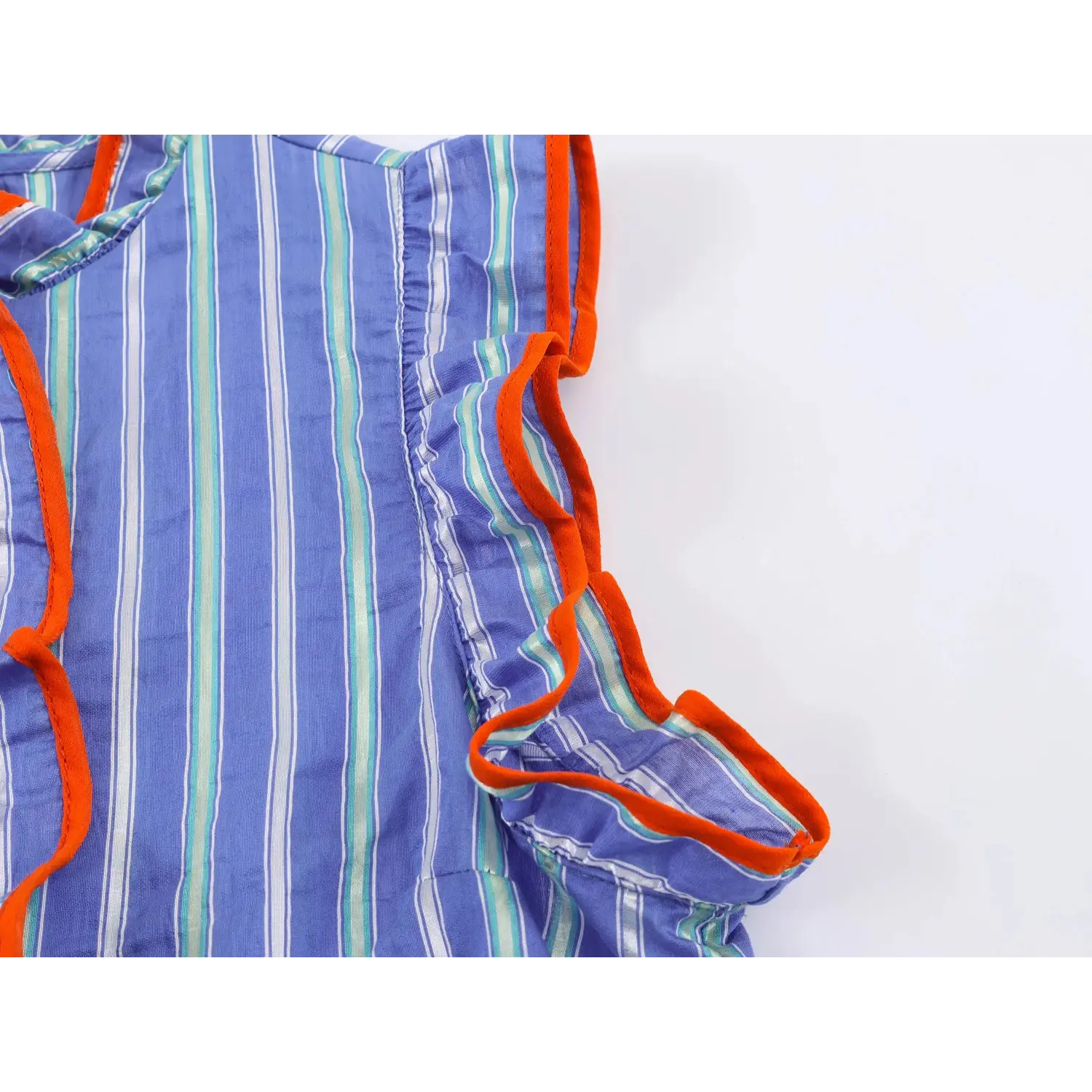 Shoulder wing ruffle sleeve close-up, orange binding edge, vertical stripe woven fabric, gathered ruffle trim along armhole
