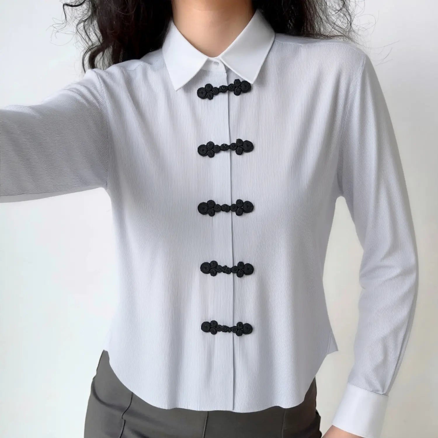 Front lifestyle shot on model of blue white pinstripe long sleeve shirt, traditional chinese frog knot placket, casual new chinese style outfit
