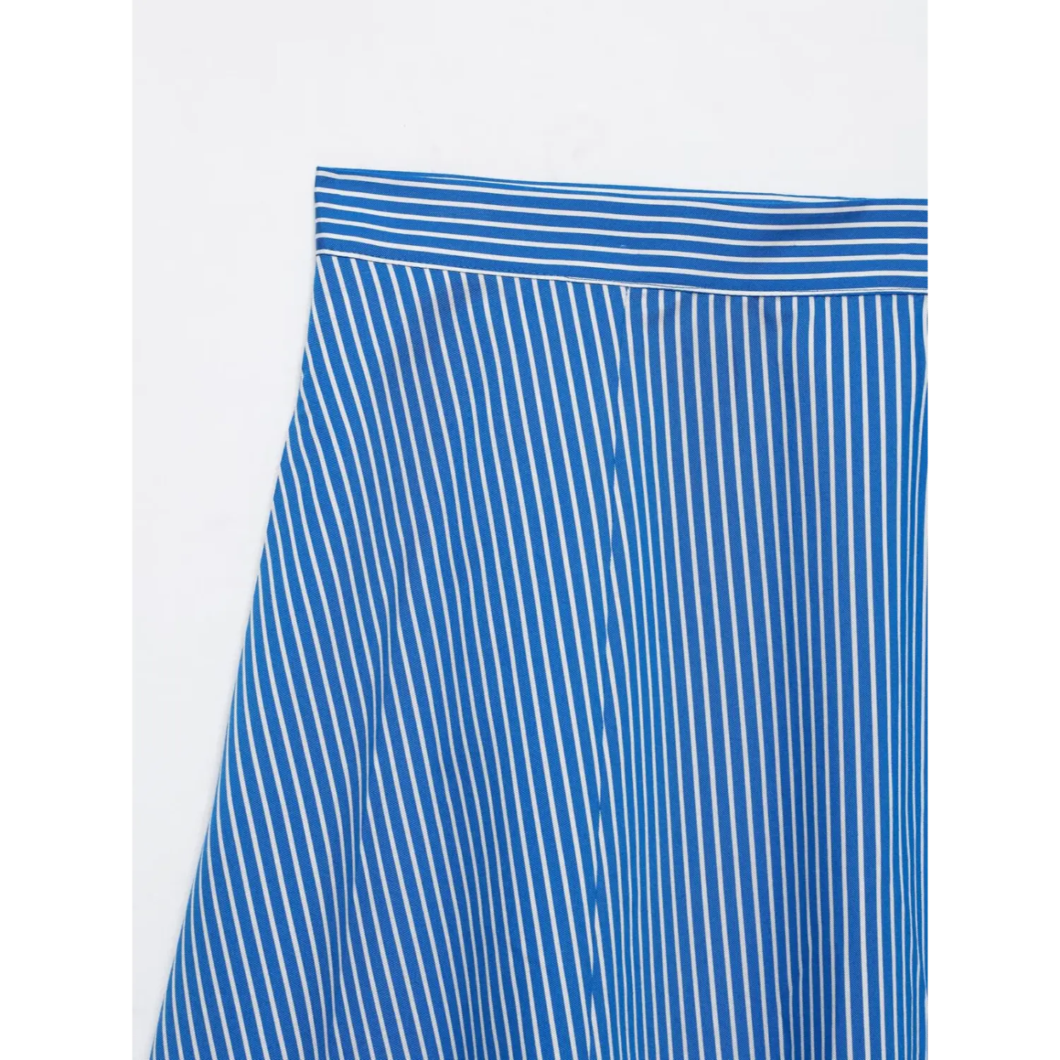 Close-up of high waistband on blue white vertical stripe midi skirt, matching striped waist trim and front panel seams
