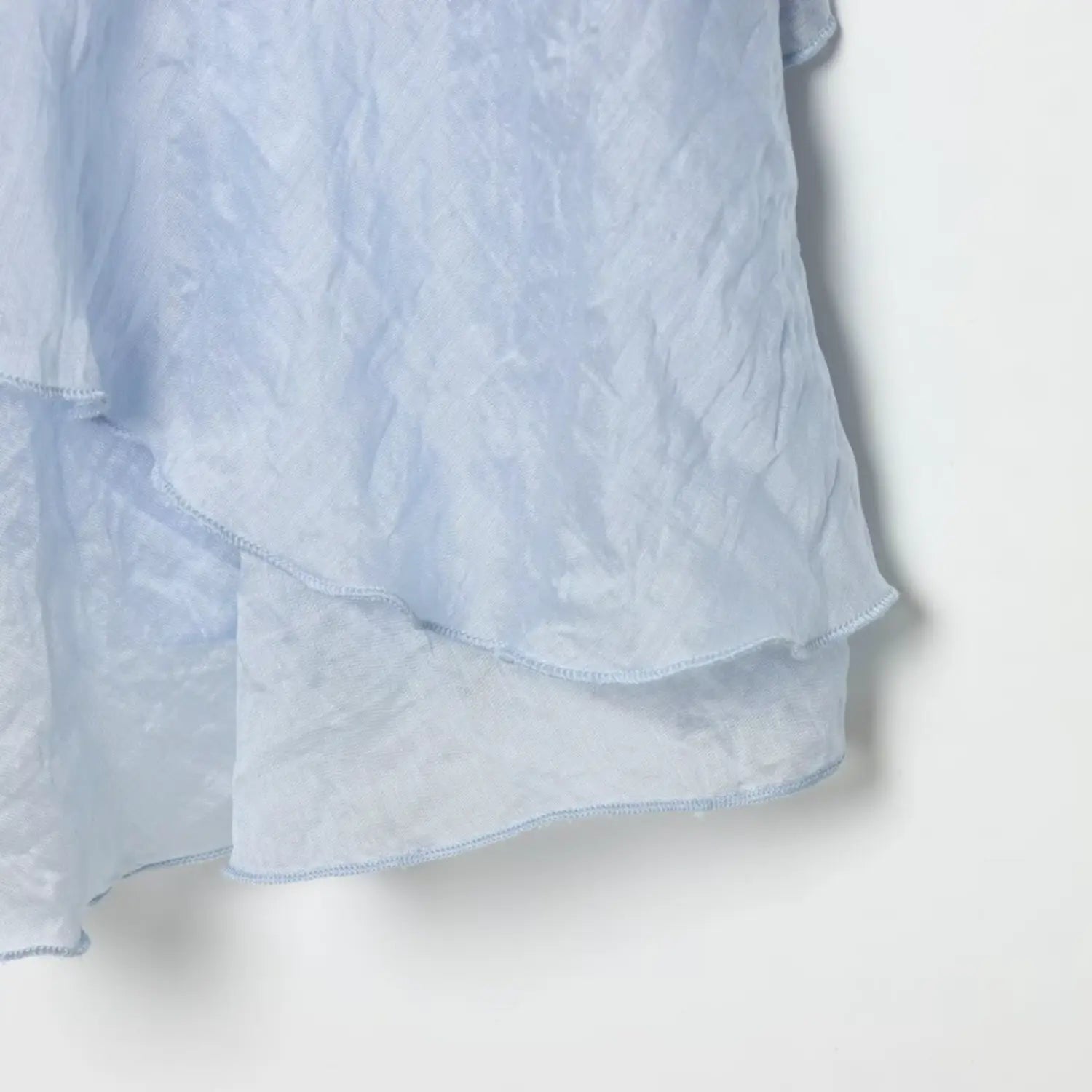 Double layer skirt hem partial shot, lightweight semi-sheer crinkled blue woven fabric