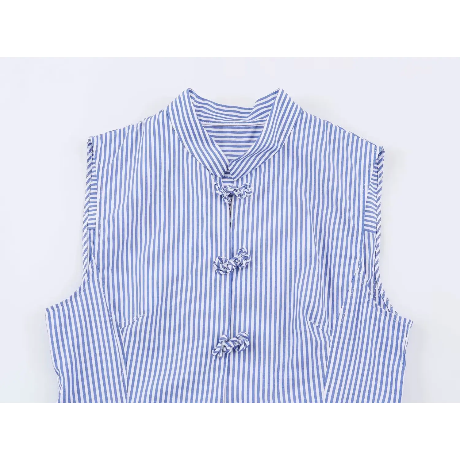 Flat closeup of mandarin stand collar, traditional fabric frog buttons on blue vertical stripe sleeveless peplum blouse