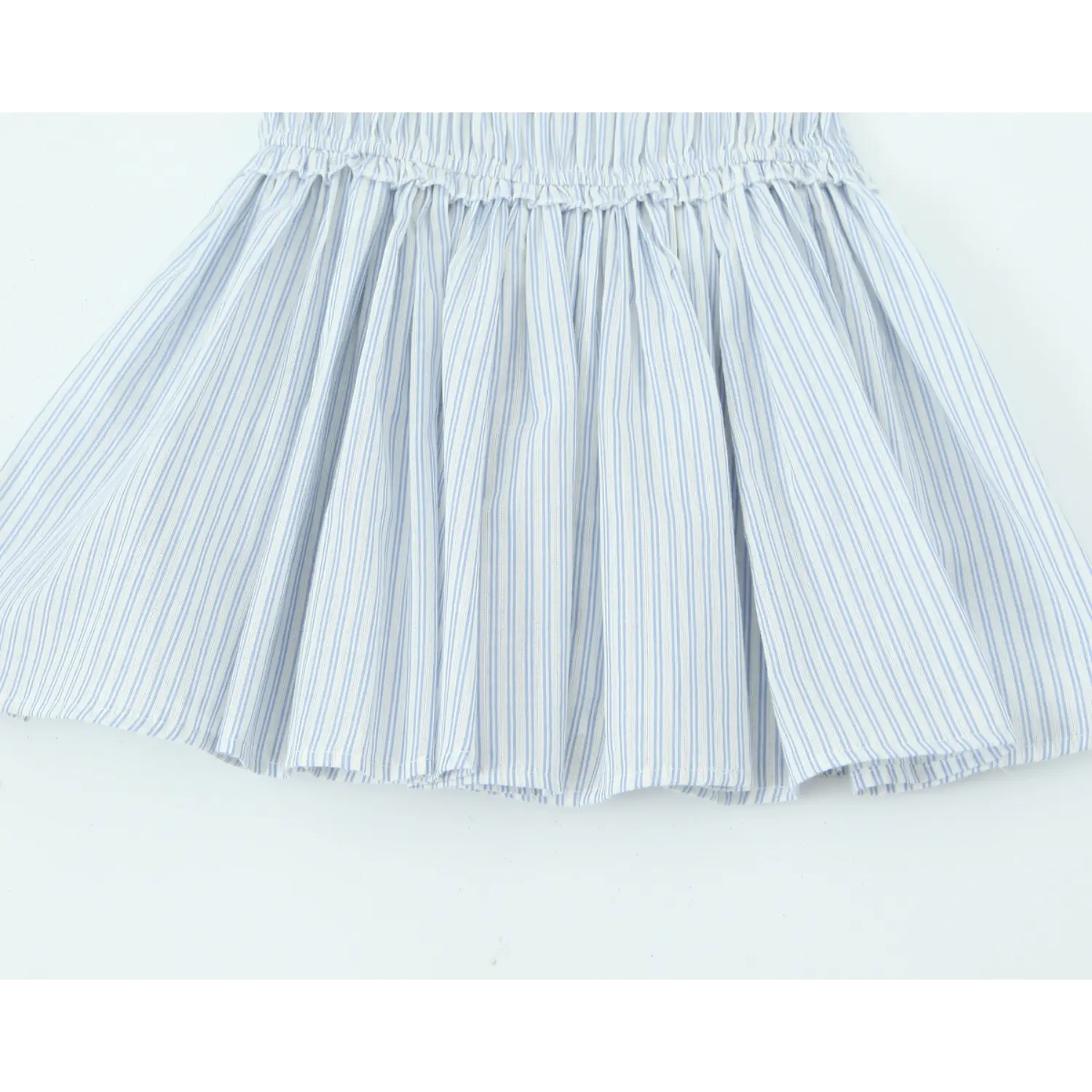 Overview of flare skirt for blue white vertical stripe mini dress, gathered smocked waist, flowy pleated silhouette, white background