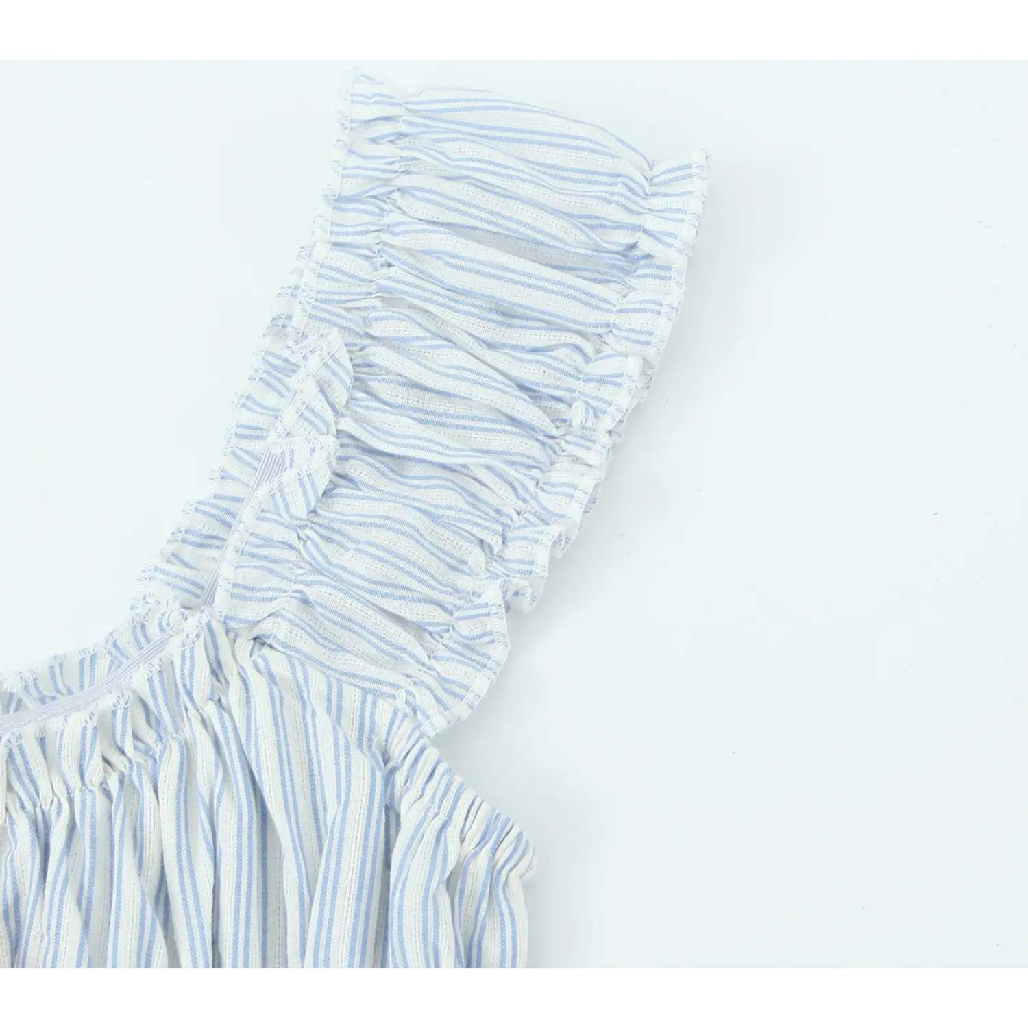 Macro detail of elastic ruffle frilled shoulder strap, blue and white vertical stripe woven fabric texture