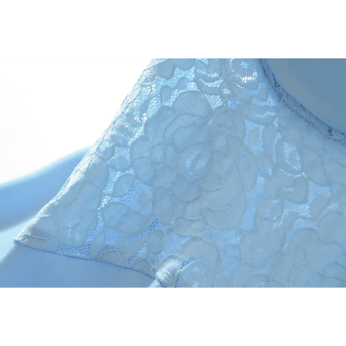 Close‑up of floral lace overlay on bust section of blue camisole maxi dress