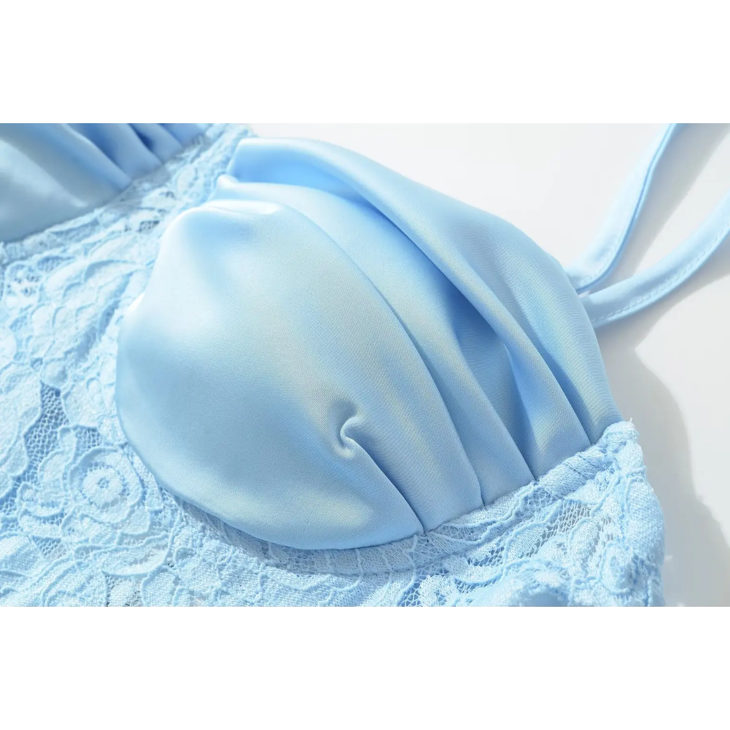 Close‑up of ruched bust combined with floral lace for blue satin maxi dress