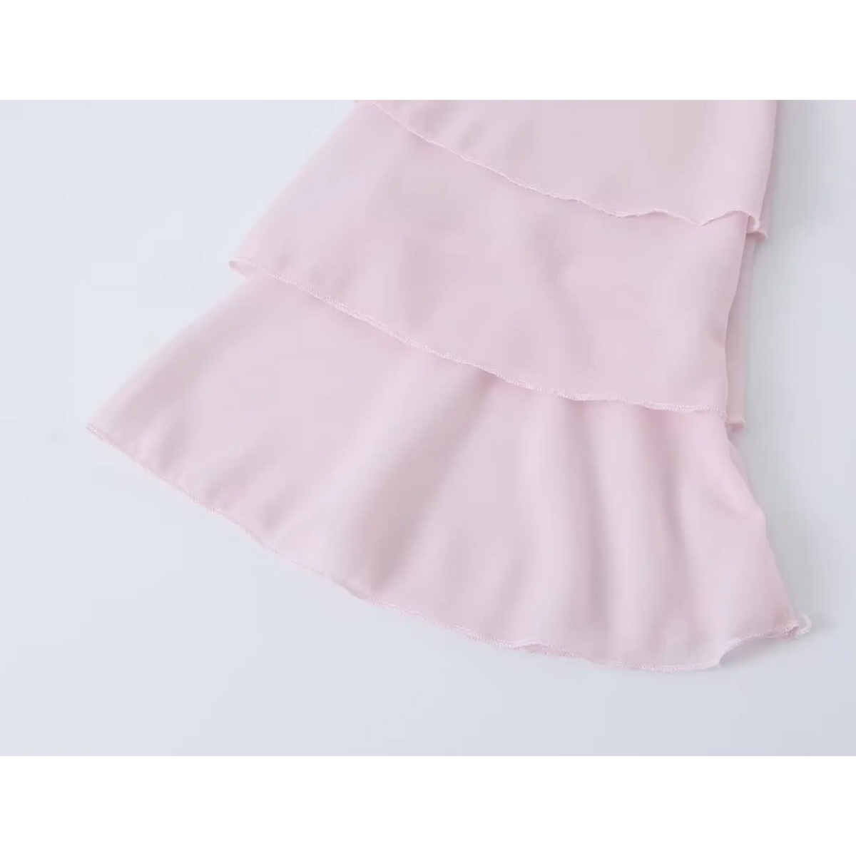 Close-up of tiered bell sleeve cuff