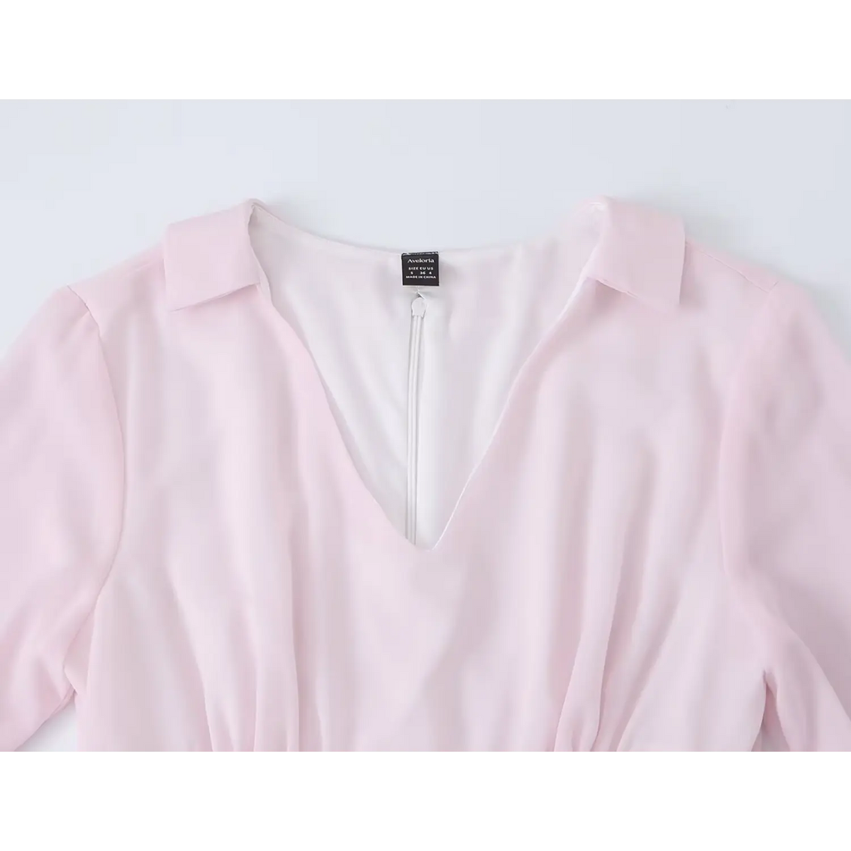 Close-up of collared V neckline and back zipper