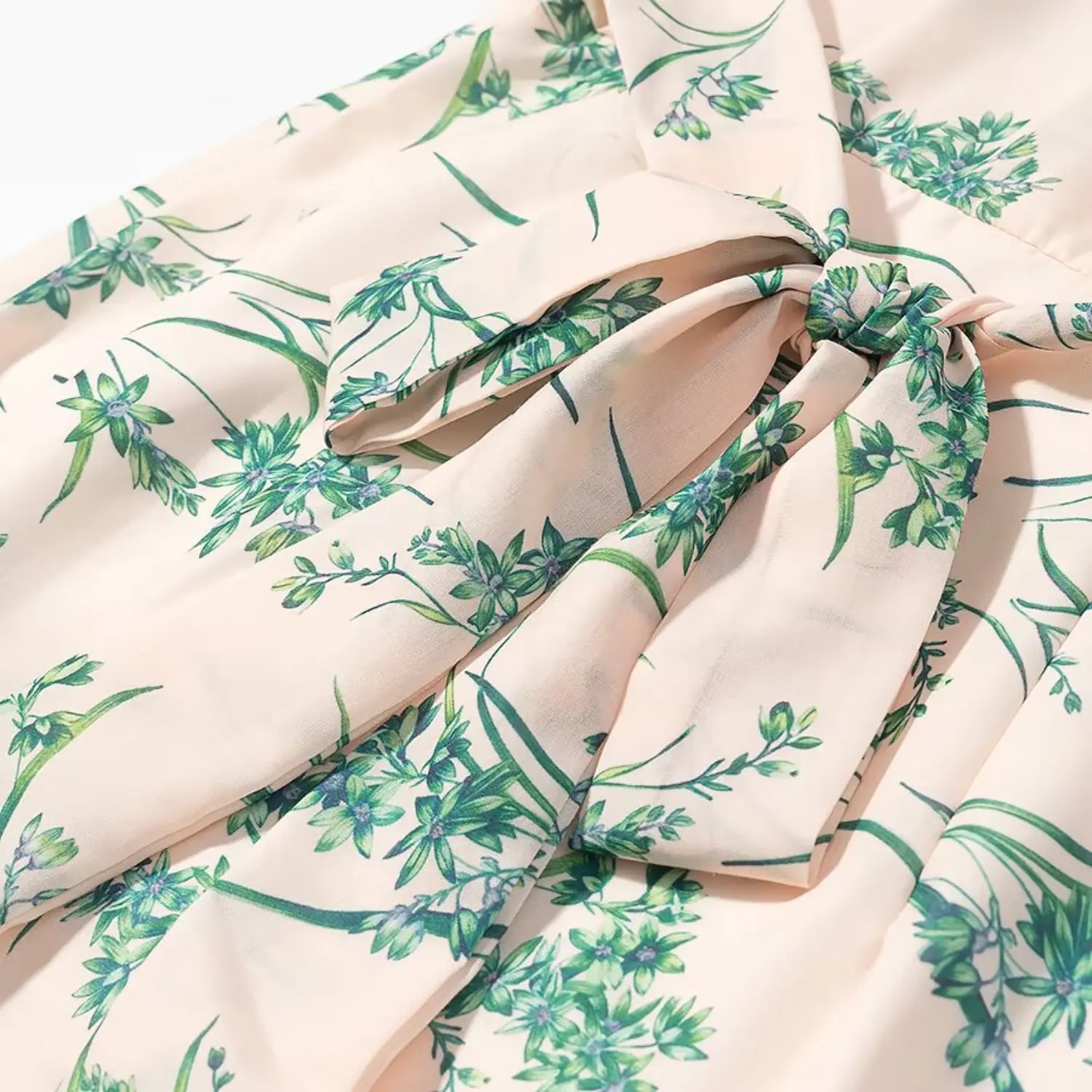 Close‑up detailed shot of fabric self‑tie bow at back waist matching floral print