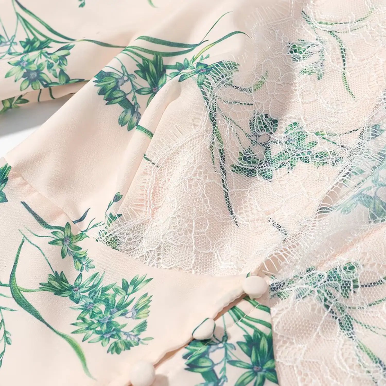 Extreme close‑up of front decorative buttons and white lace trim on v‑neck bust area