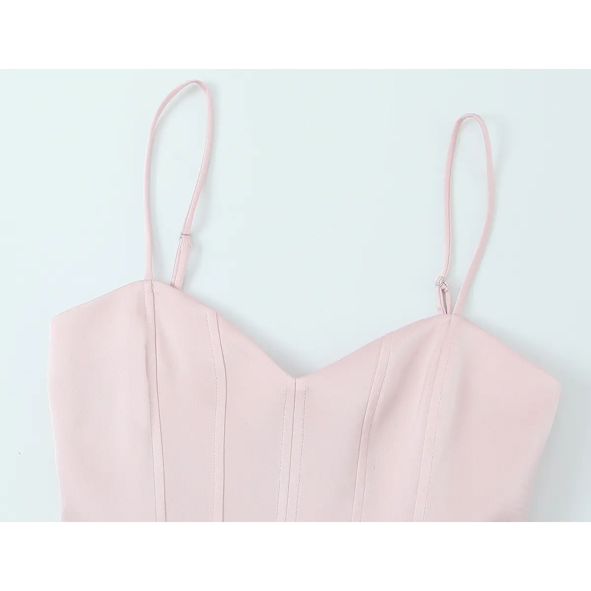 Front view of the blush pink bustier top, showing the sweetheart neckline, structured boning, and adjustable straps