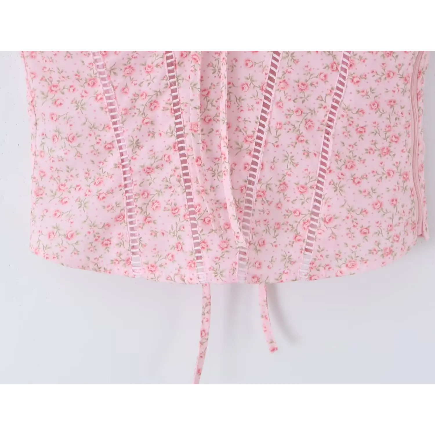 Bottom hem detail, multiple vertical ladder cutout panels, curved cropped hemline