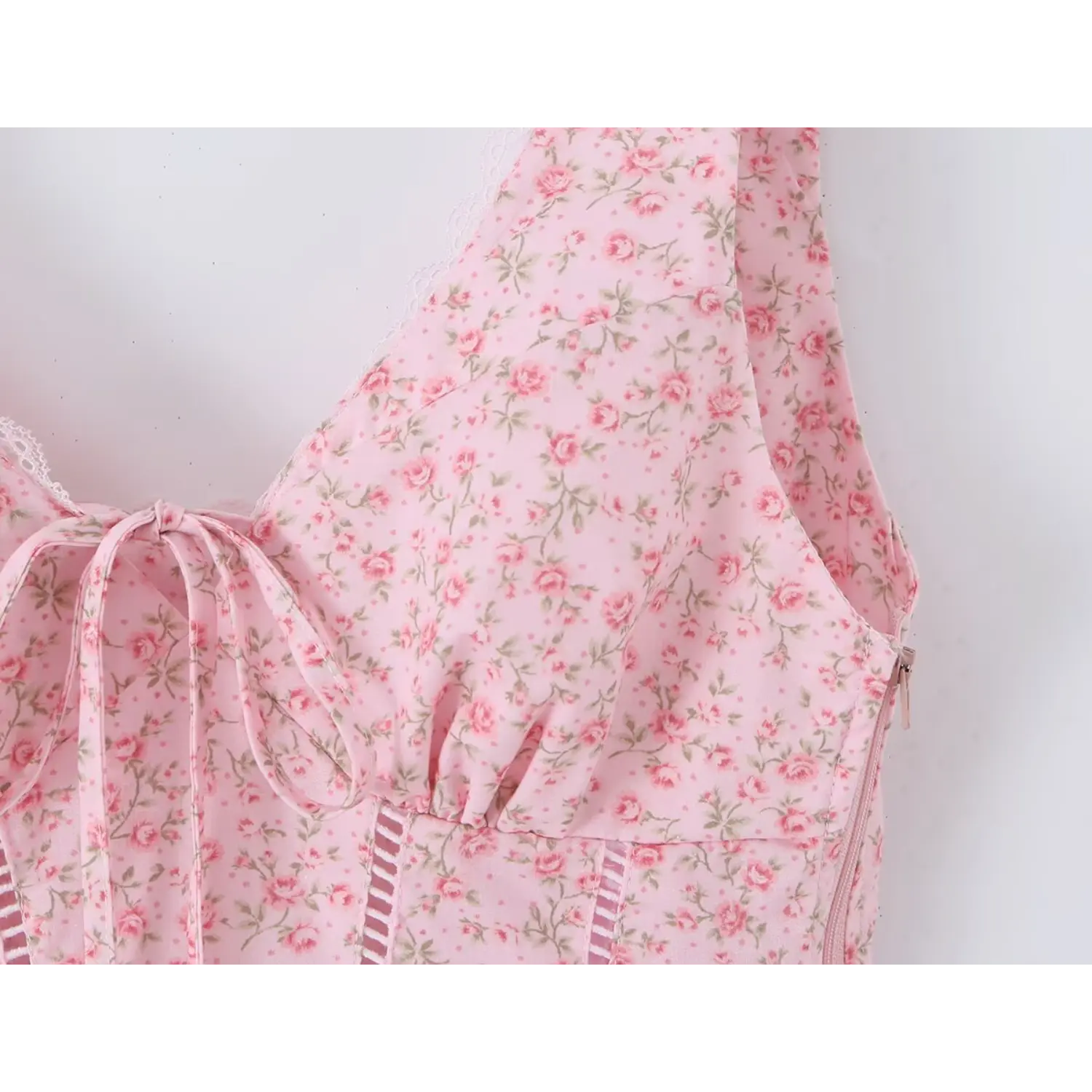 Front bust tie closeup, invisible side zipper, vertical ladder cutout stitching on floral fabric