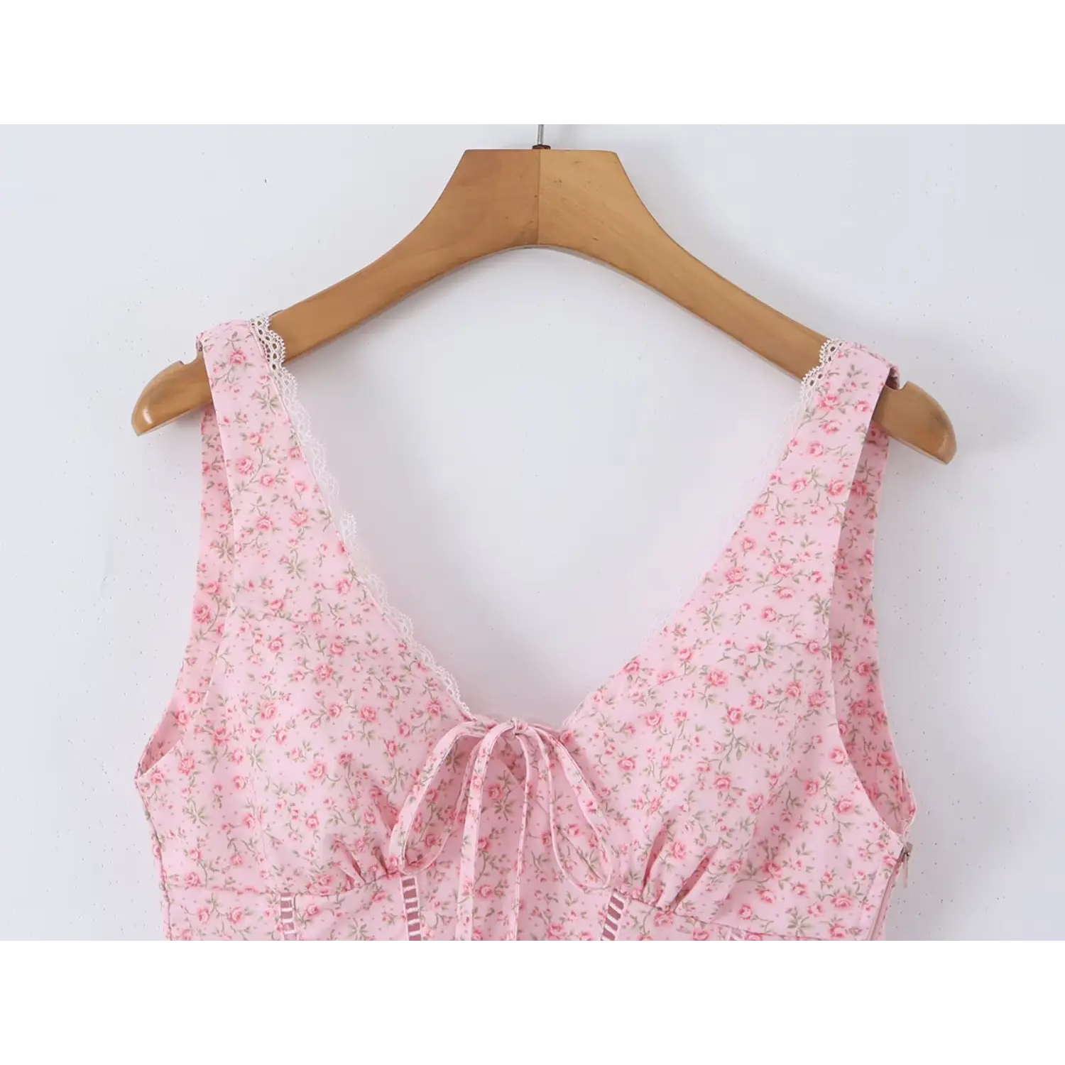 Closeup front v neckline, lace edge shoulder straps, bust self tie knot, small rose floral print fabric
