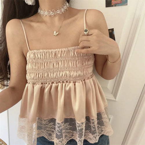 Close-up view of the blush pink cami top, showing the smocked texture, adjustable spaghetti straps, and layered lace hem