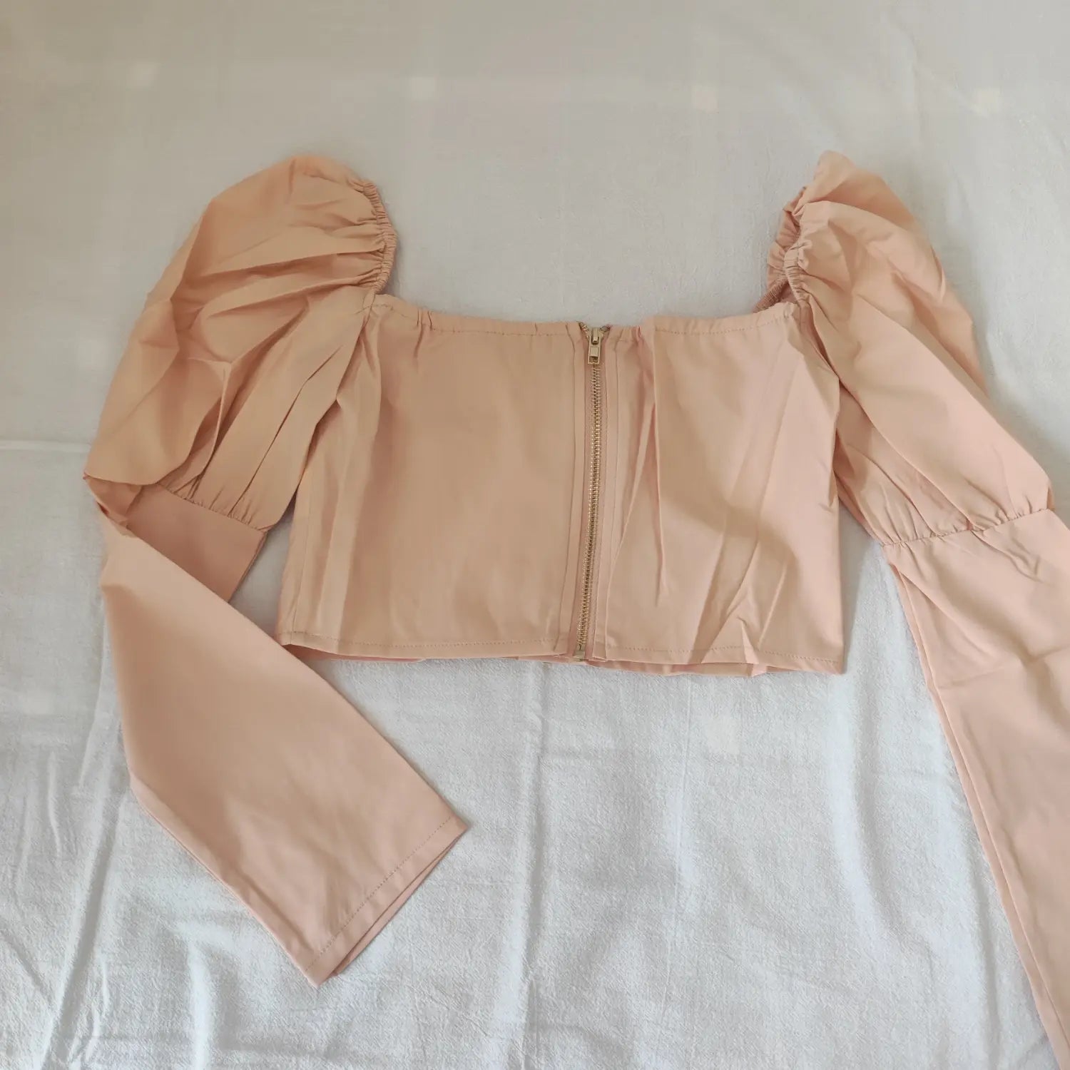 back-flatlay-view | Flat lay back view blush pink cropped top with center back zipper