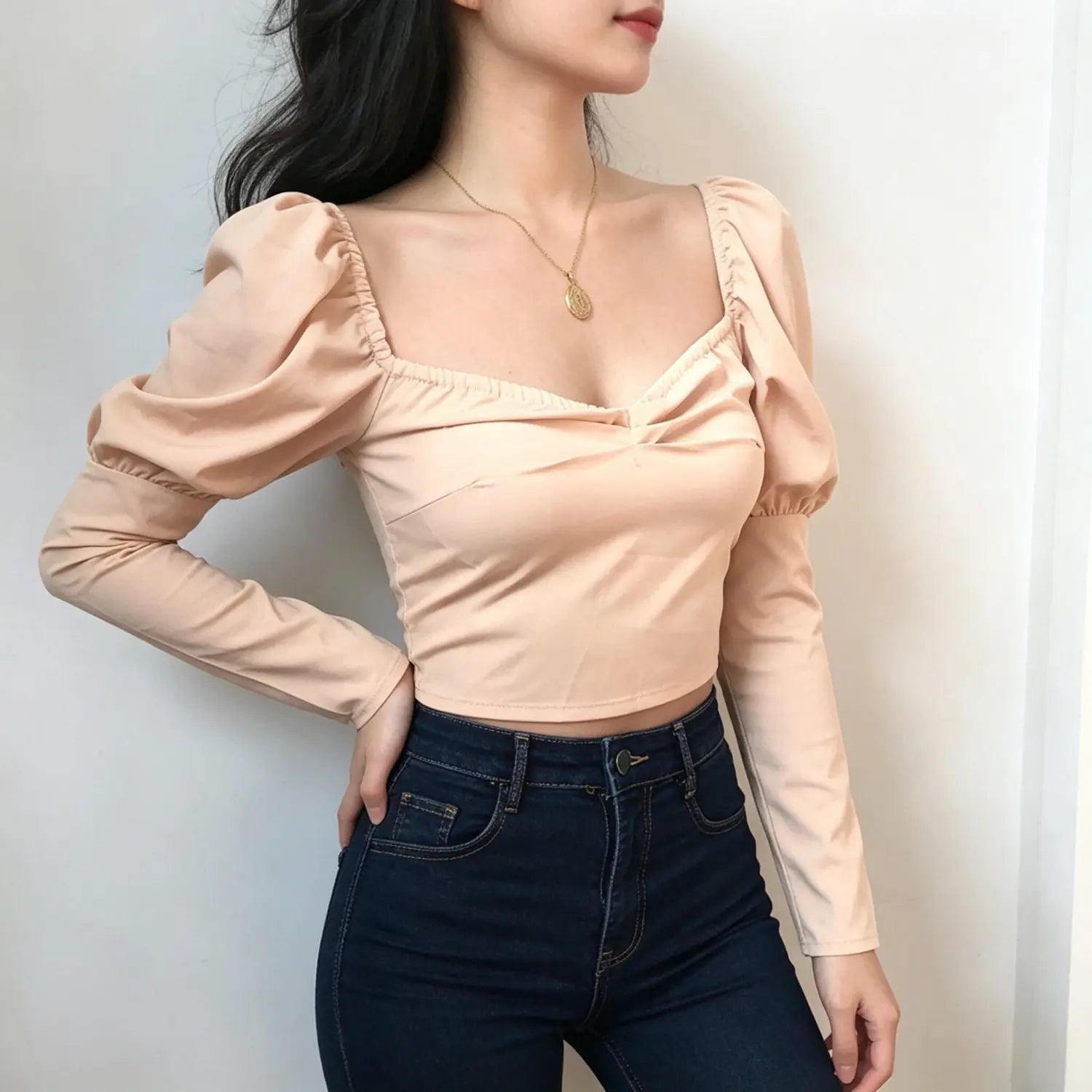 model-threequarter-view | Three quarter model shot blush pink fitted puff sleeve cropped blouse