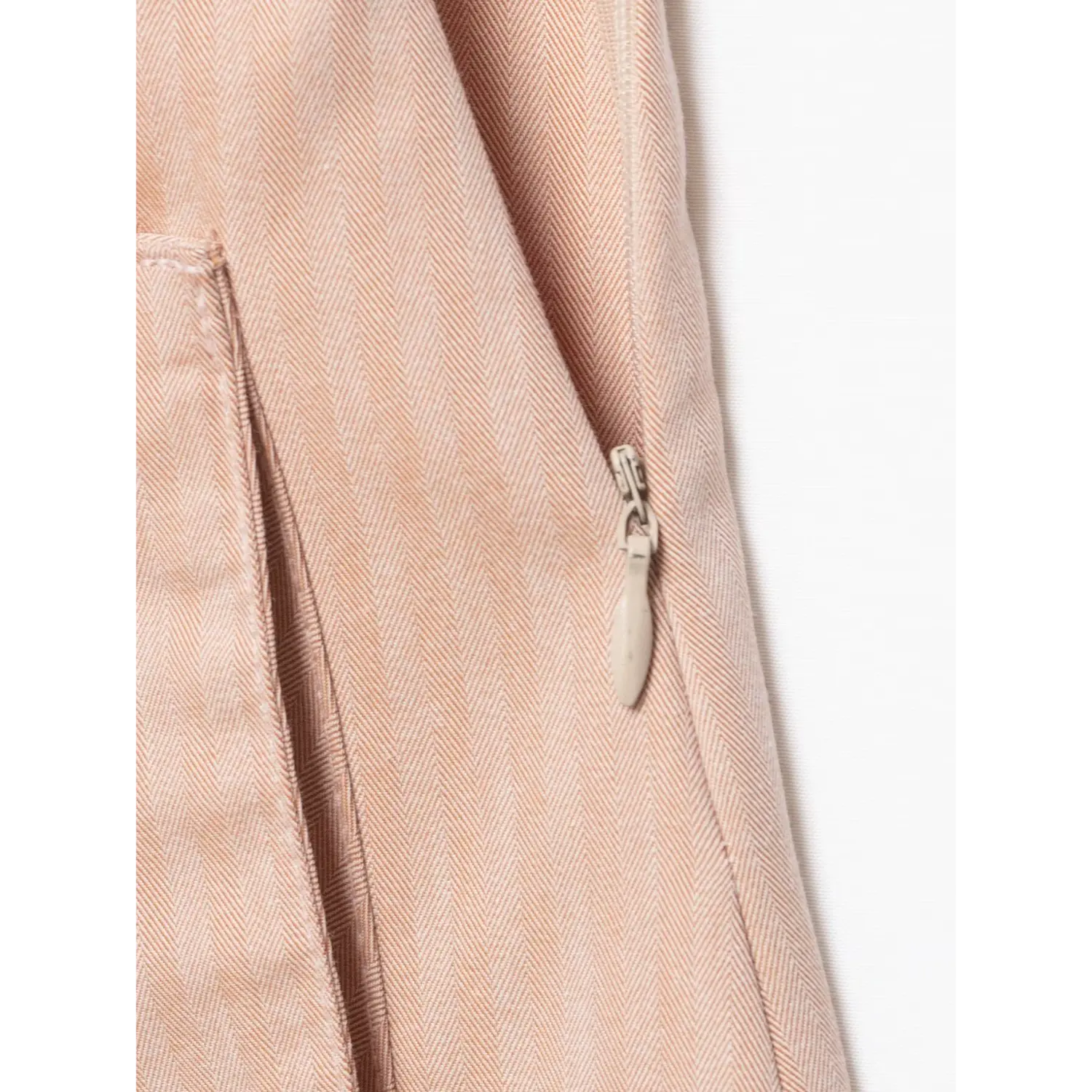 Close‑up side invisible zipper pull detail blush pink vertical stripe mini skirt