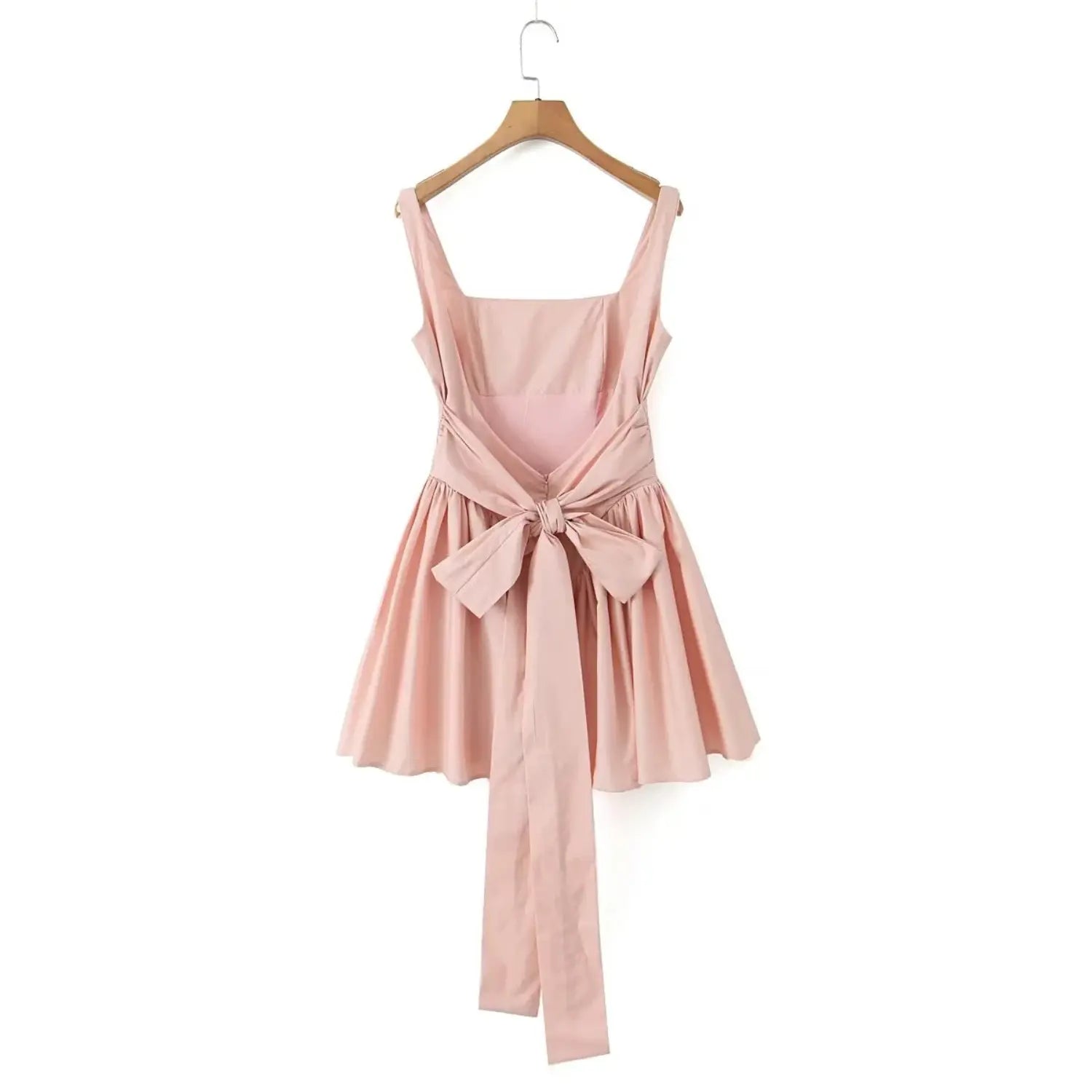 Hanging full back view blush pink mini dress, open back design, large fabric bow tie with long sash tails, gathered skater skirt