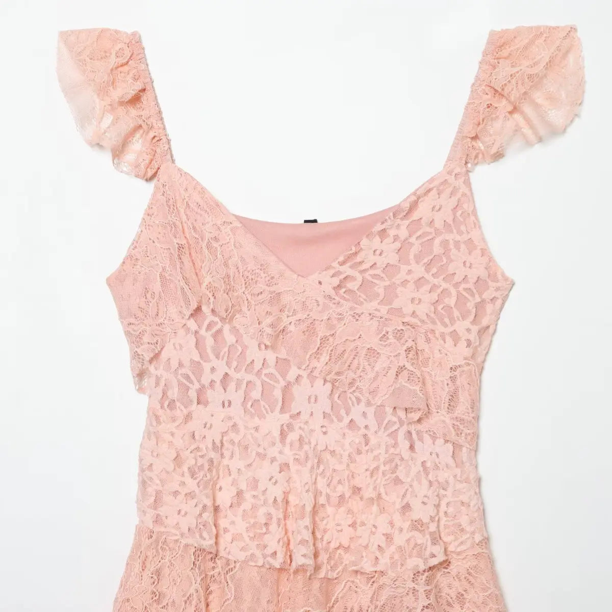 Front view of the blush pink tiered lace dress, showing the V-neckline, ruffled straps, and tiered bodice