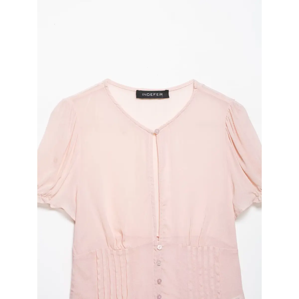 Full front studio shot of the blush pink V-neck puff sleeve blouse, showing the button placket and pleated waist.