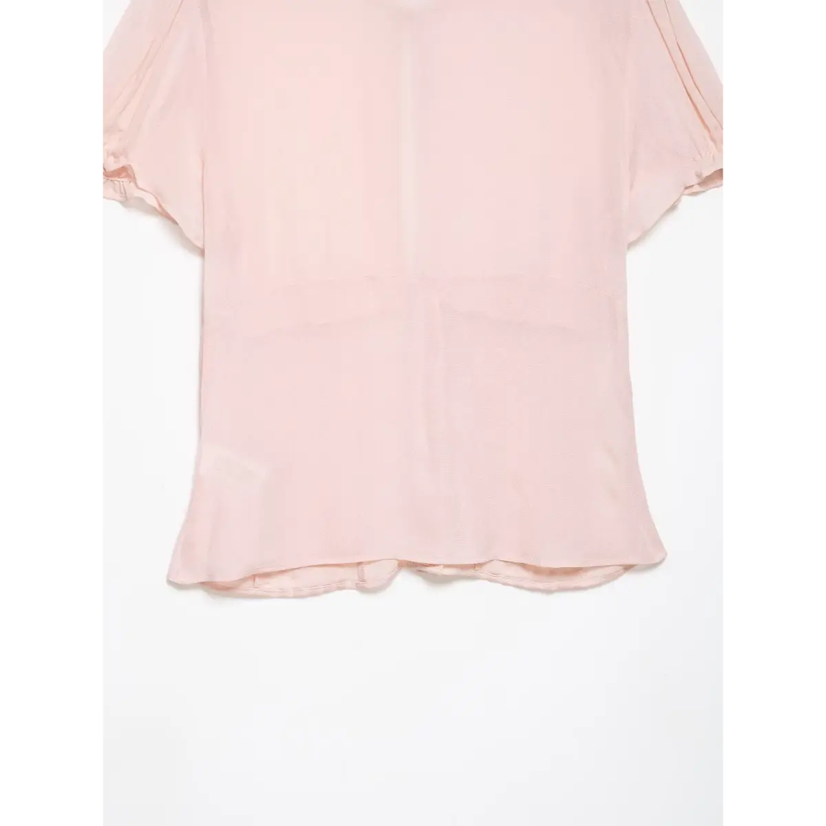 Detail shot of the finished back hem on the blush pink blouse.
