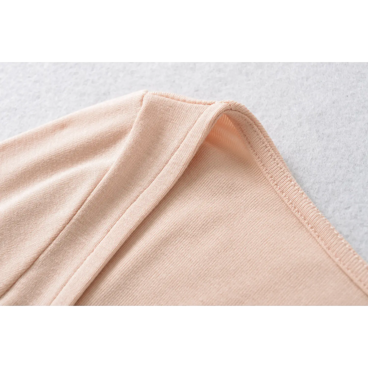 Blush pink wide shoulder strap seam binding close up, neat fine stitching square neck women crop top