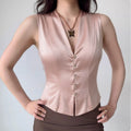 Model front wearing shot tailored blush pink satin sleeveless vest v‑neck with decorative buttons