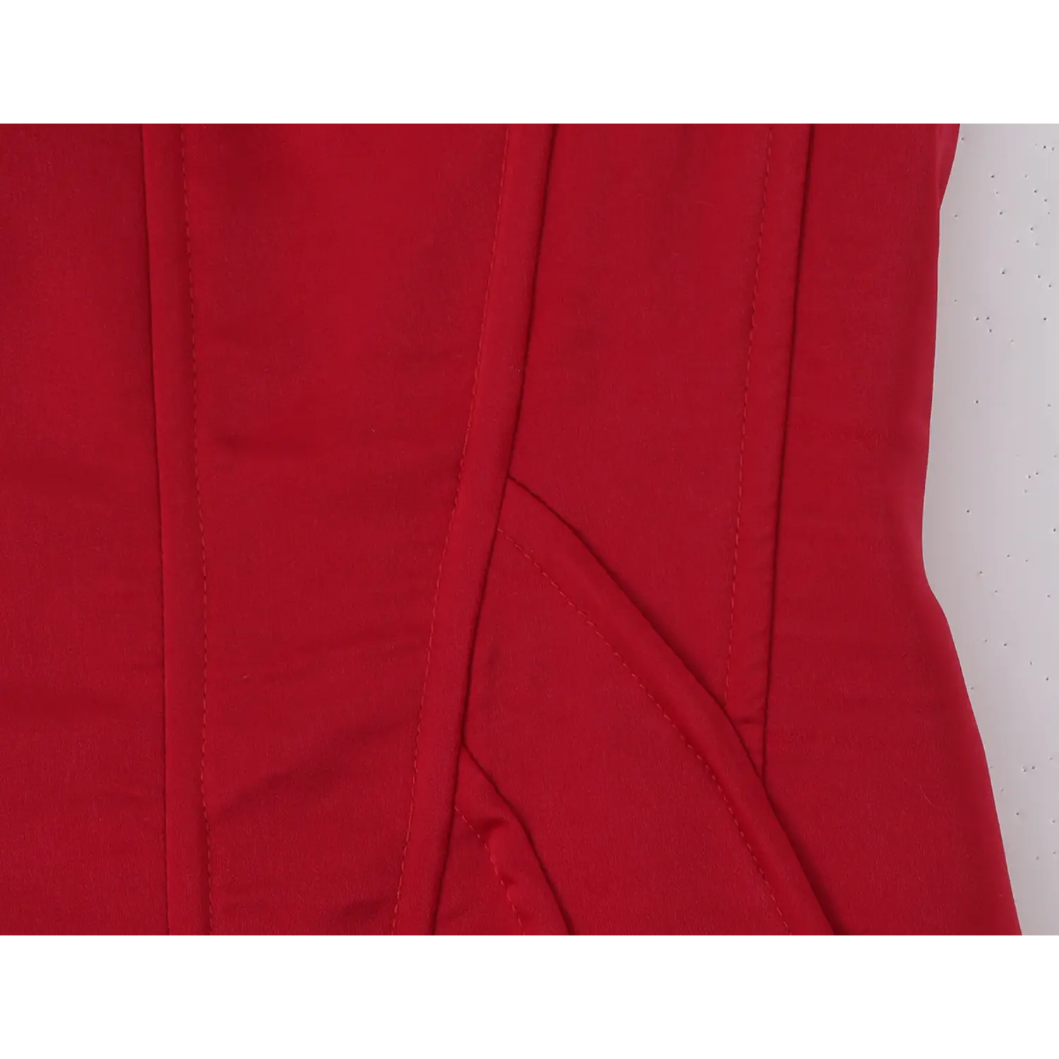 Torso partial close-up, vertical corset boning seams, tailored waist shaping stitching, structured bodice panel