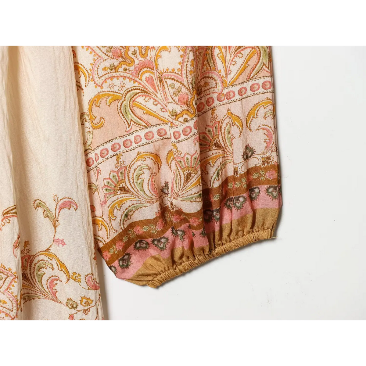 Close‑up of balloon sleeve elastic cuff with border paisley print