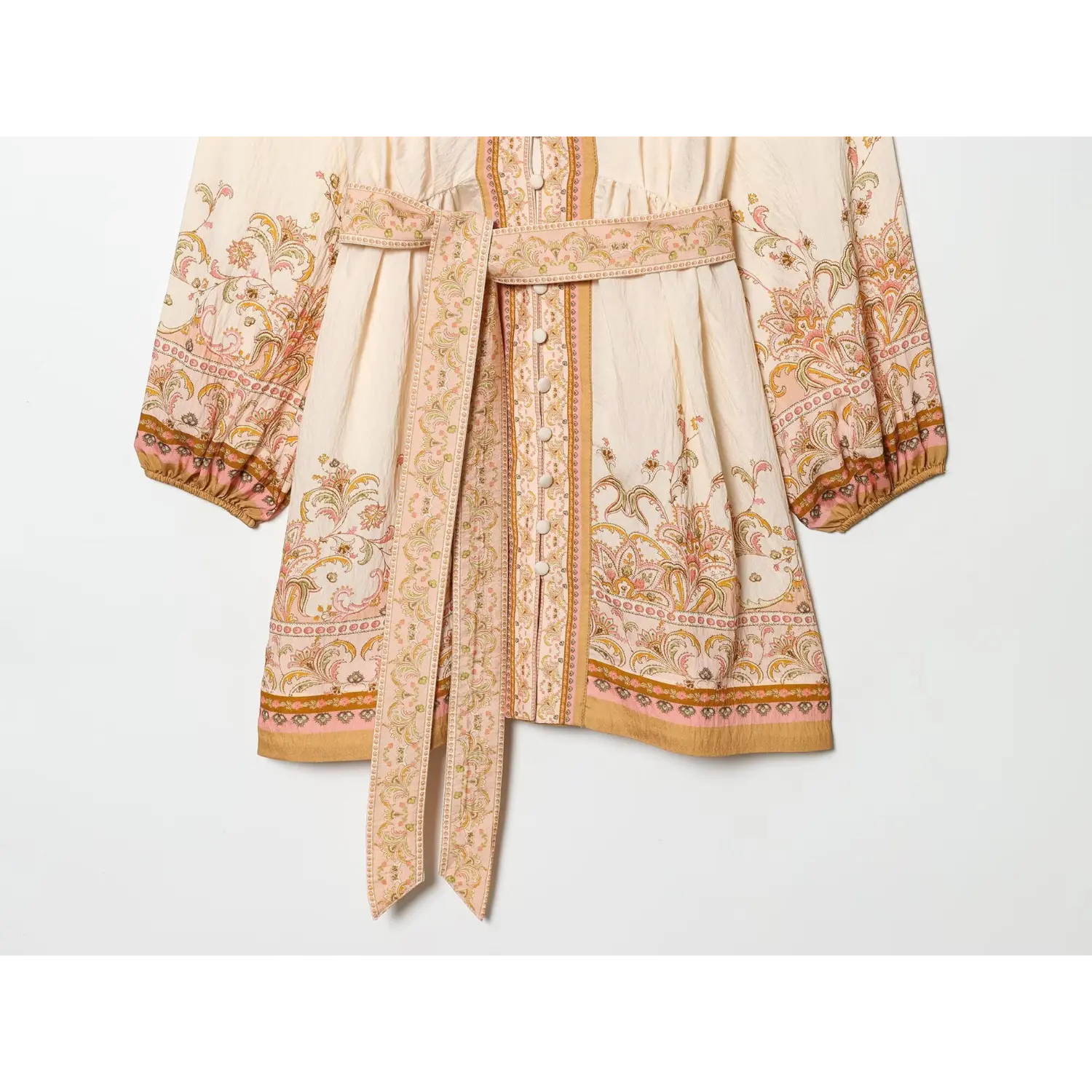 Close‑up view of matching printed tie belt, waist seam and dress hem border print