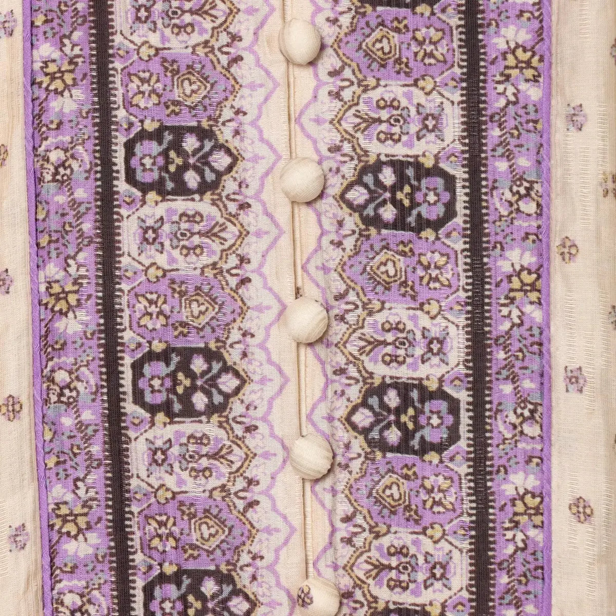 Close-up of the decorative front button placket on a boho printed mini dress, showing the intricate purple pattern.
