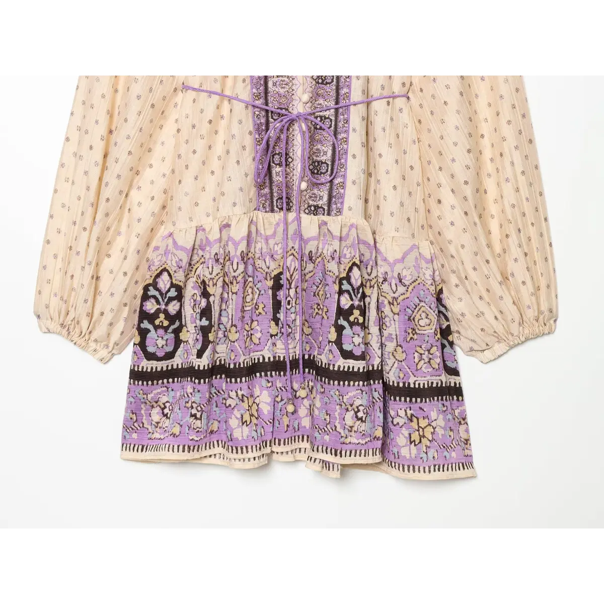 Full view of the gathered skirt on a boho printed mini dress, showing the decorative purple border and tie waist detail.