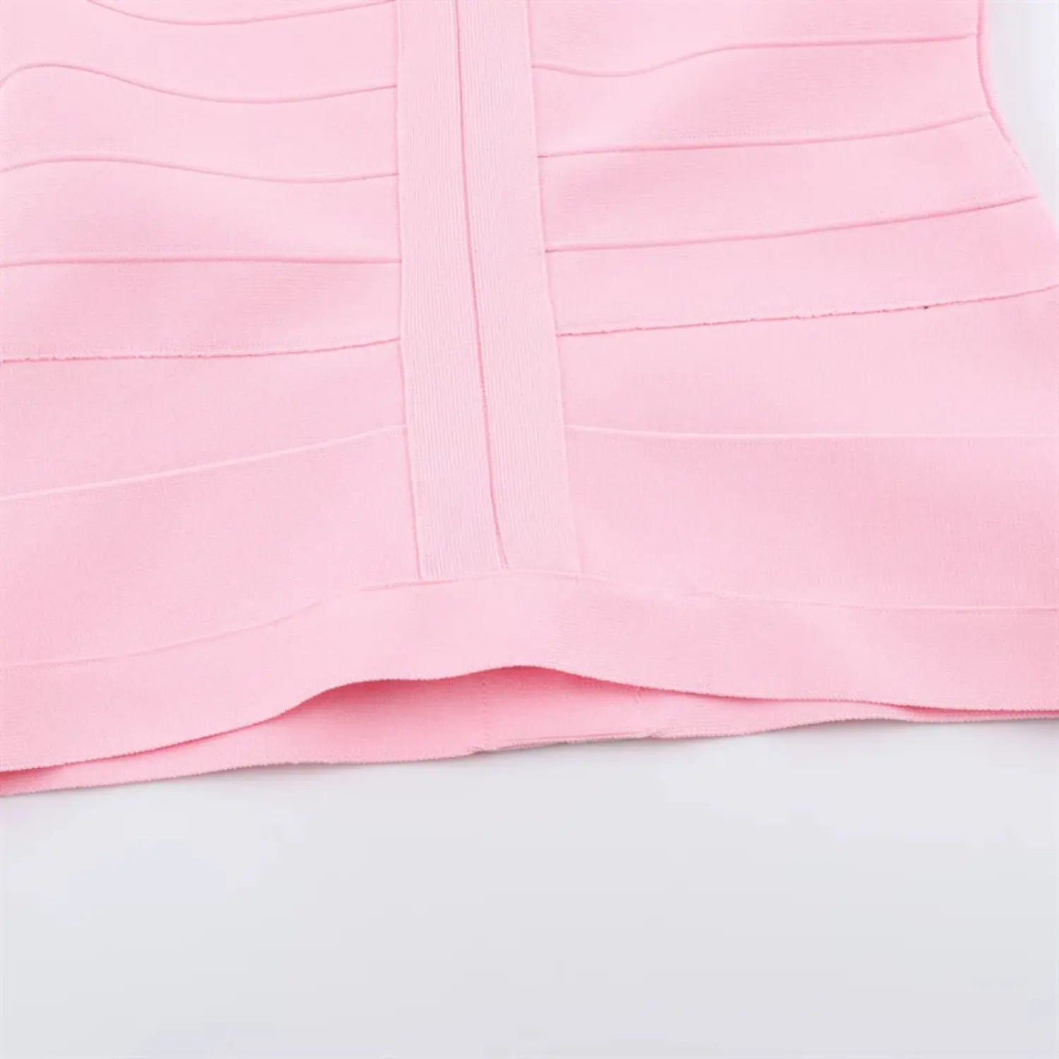 Cropped hem partial shot, wide horizontal bandage panel at hem, folded edge finishing, consistent stretch knit drape