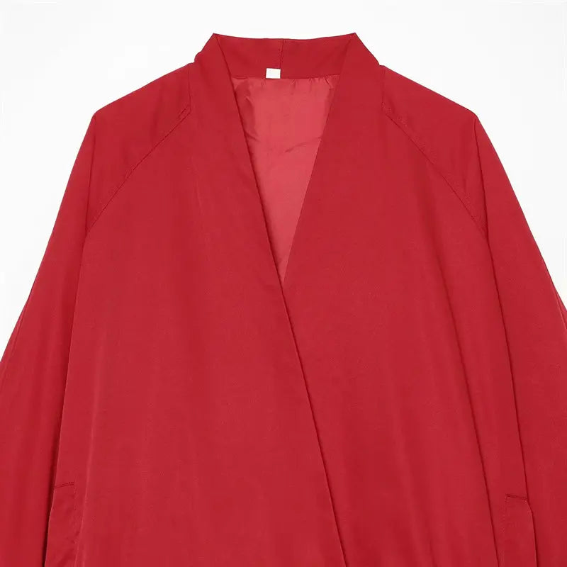 Front flat lay solid red surplice wrap lightweight jacket, deep crossover V neck, side patch pockets, loose cropped elastic hem