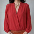 Lifestyle model wearing bright red wrap front lightweight jacket, deep surplice V neck, loose bubble long sleeves, cropped elastic waist hem, daily casual outerwear match