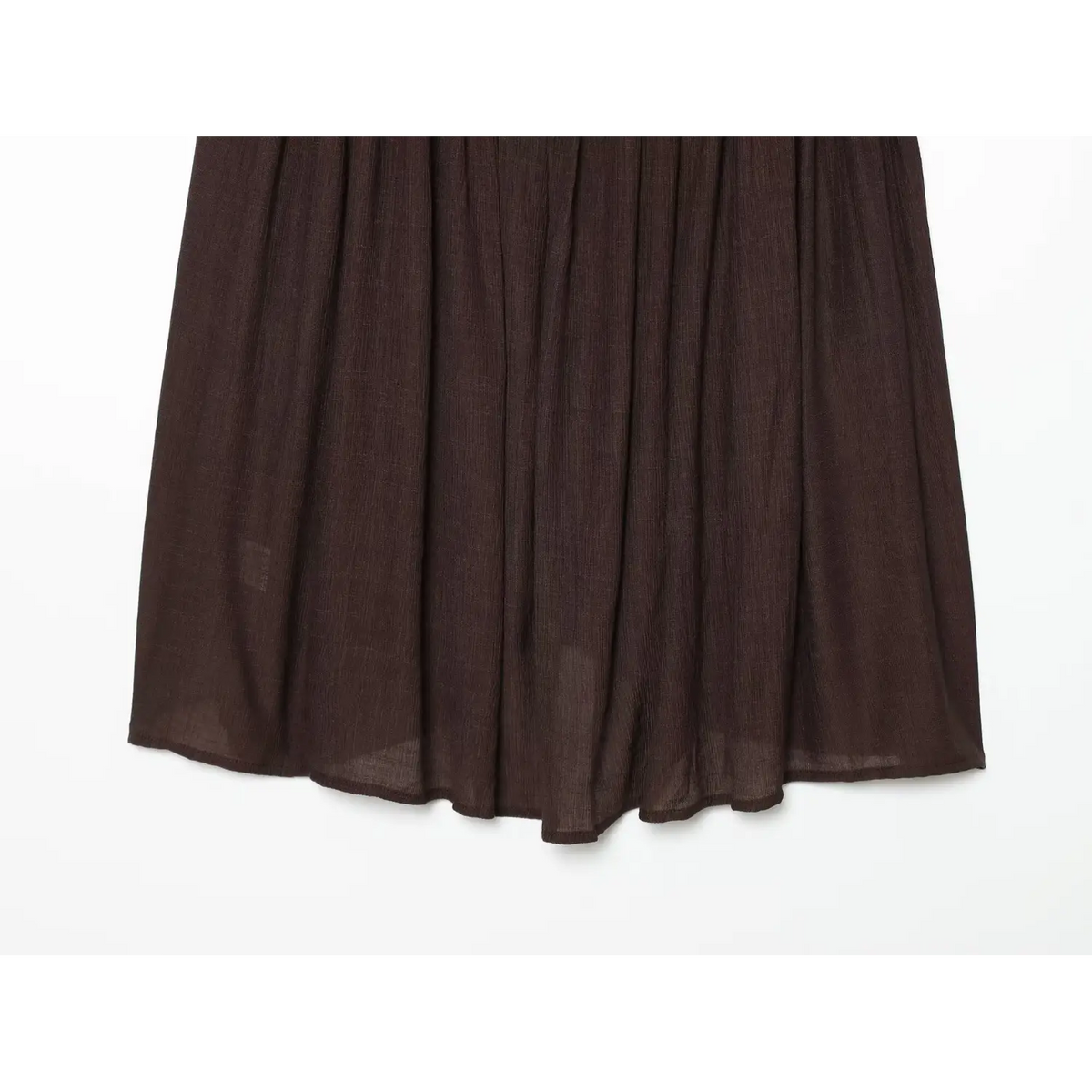 Close‑up flowy skirt and high‑low uneven hem of brown crinkle fabric cami dress