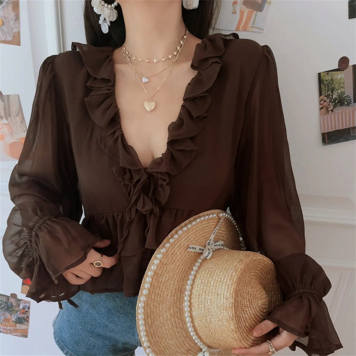 Brown chiffon ruffle crop top with pearl straw hat model side shot, highlight V neck frill trim front tie high waist cropped hem denim shorts cottagecore moody outfit shot