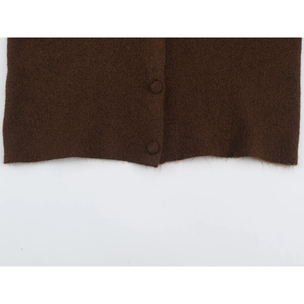 Close-up of hem and covered buttons