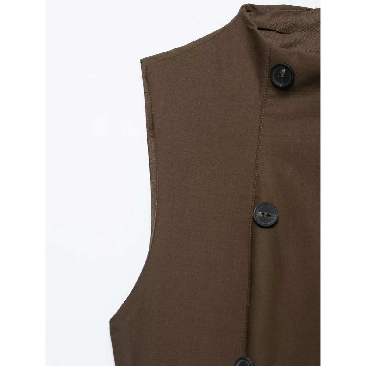 Close-up of armhole and double breasted buttons on brown dress