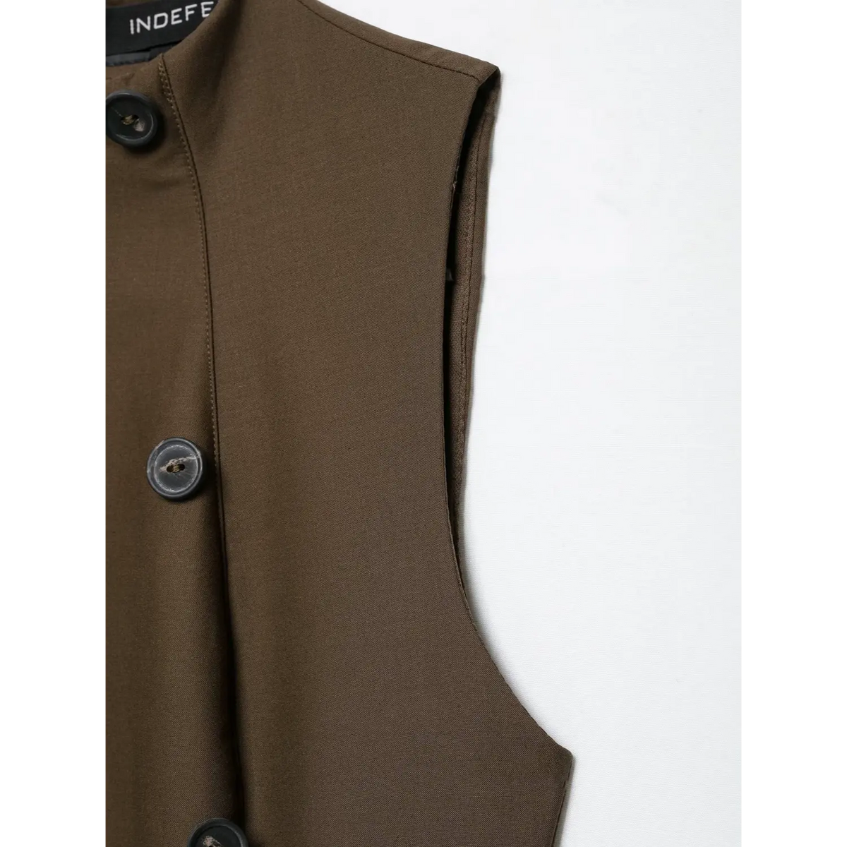Close-up of armhole lining on brown mini dress