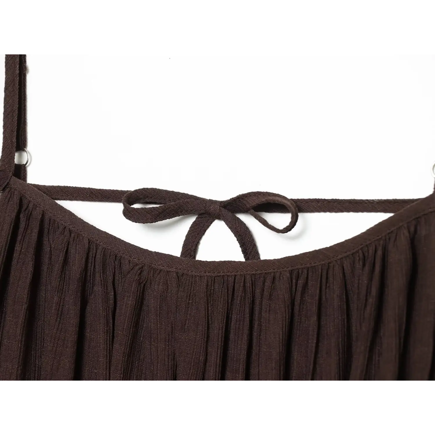 Close‑up view of fabric tie bow detail on back of brown cami mini dress