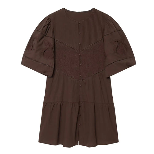 Front view of brown embroidered mini dress, round neck, puff elbow sleeves, front button placket, eyelet cutwork and tiered ruffle hem