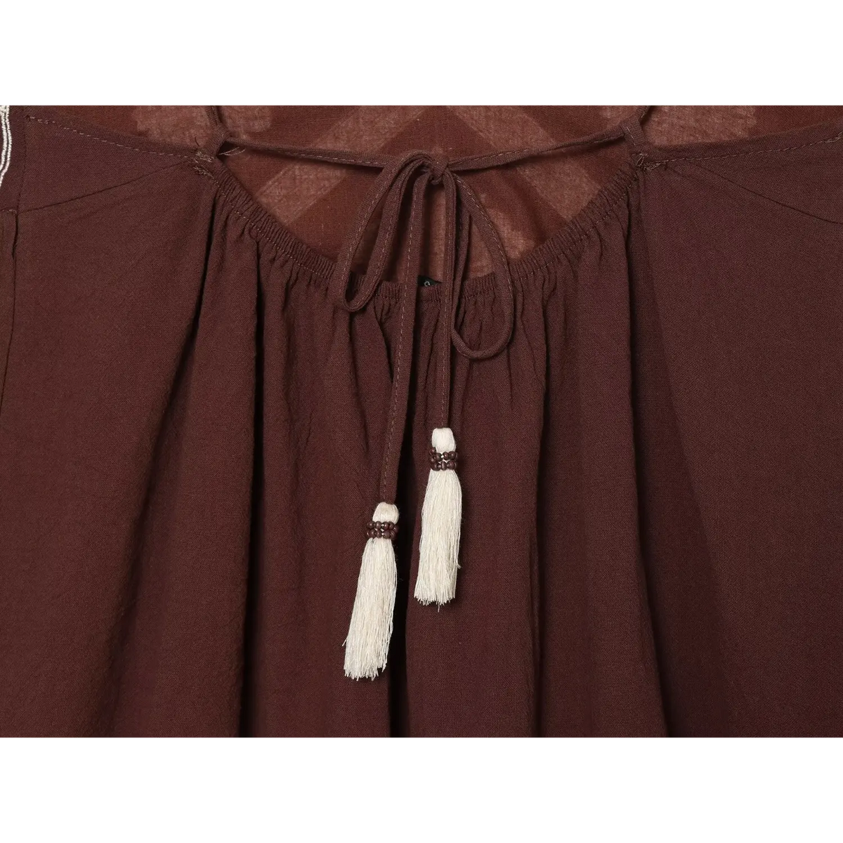 Close-up of tassel tie with wooden beads