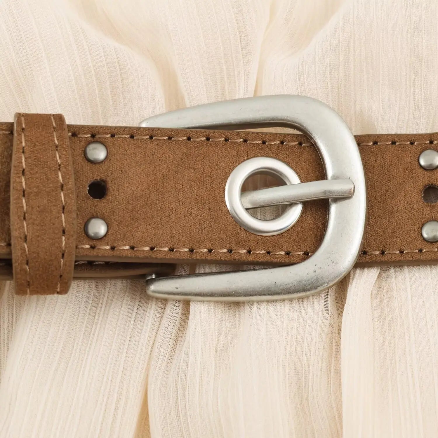 Close-up silver metal buckle on brown faux suede matching dress belt