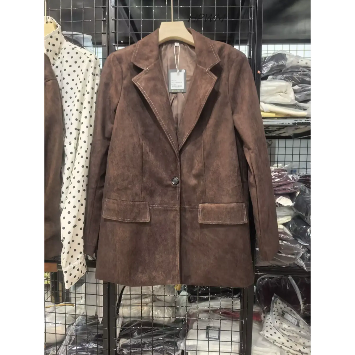 Brown faux suede blazer on hanger, front view