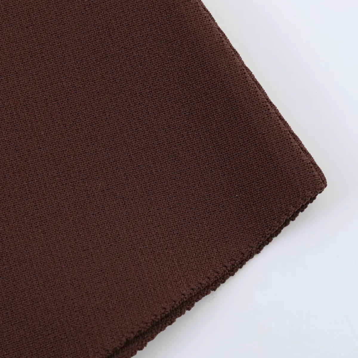 Close-up of the soft knit fabric texture on the brown tank top