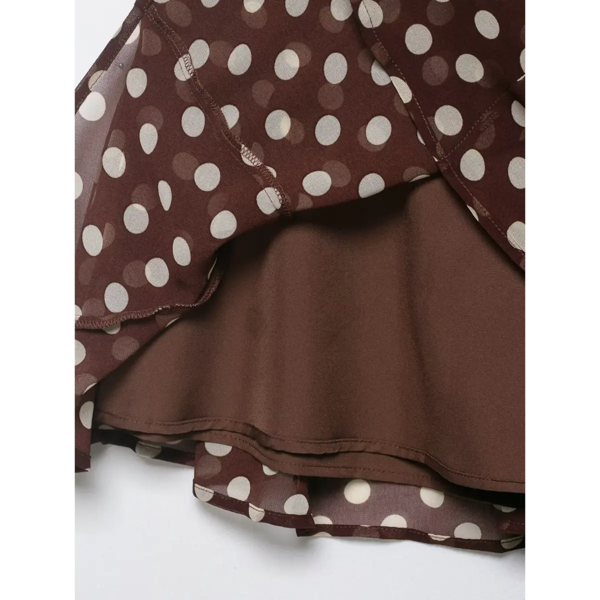 Close-up of the built-in lining and flared hem on the brown polka dot skirt