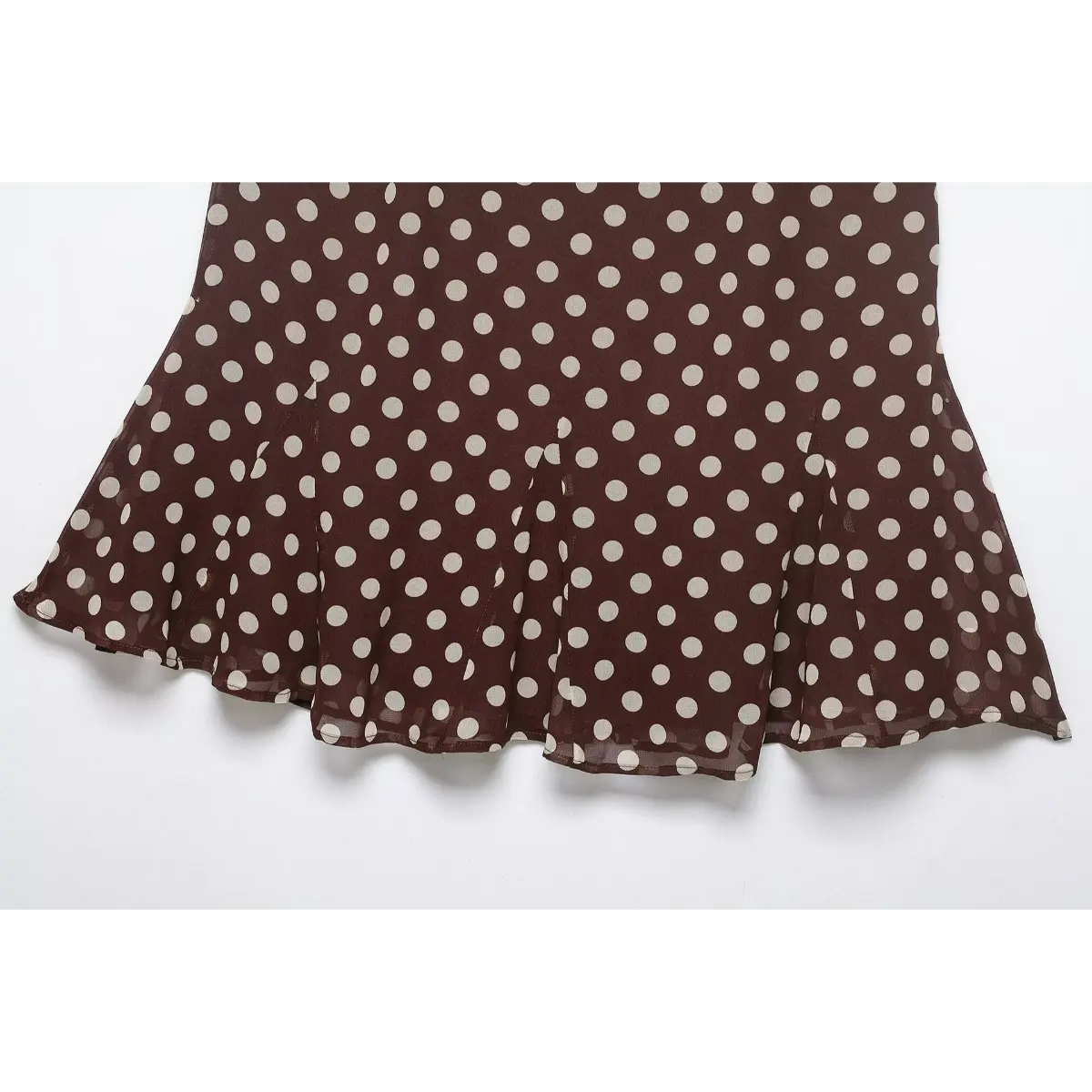 Brown polka dot mini skirt laid flat, showing side silhouette and flared hem