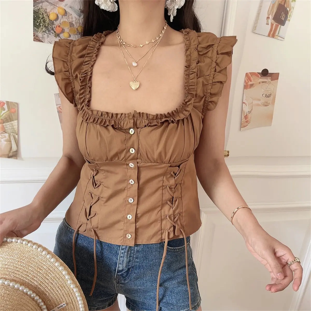 Full front hanger shot of coffee square neck frill corset short top, button front and cropped hem silhouette.